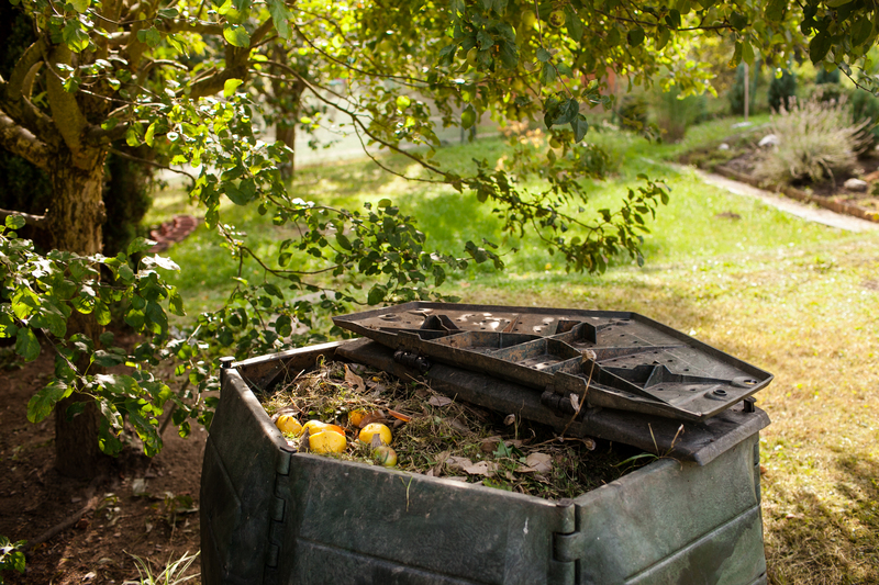 Homeowner sorting boxes and bin bags during bright spring clearout in a tidy living room